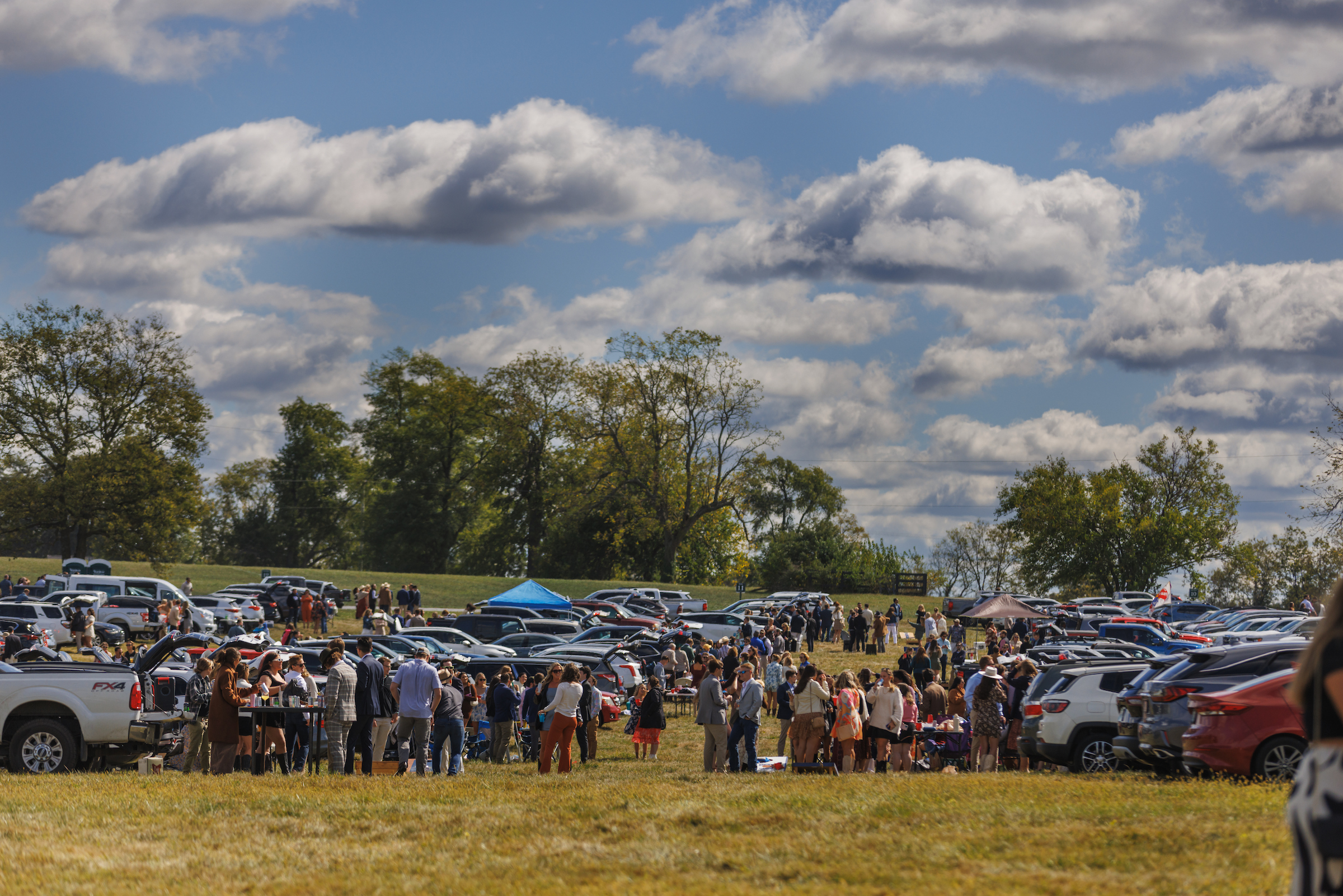 the hill grassy area with people tailgating