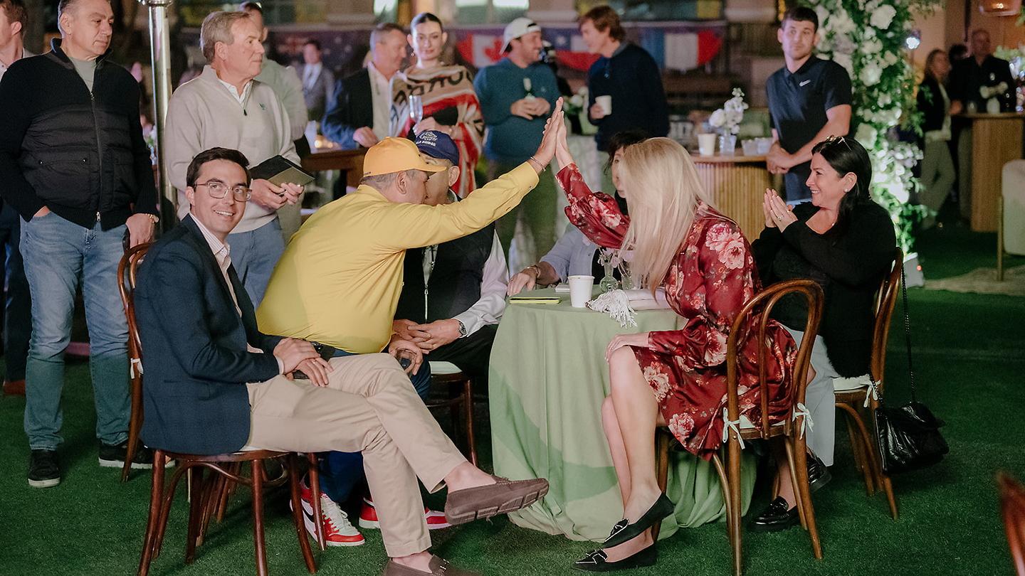 auction attendees celebrating at table