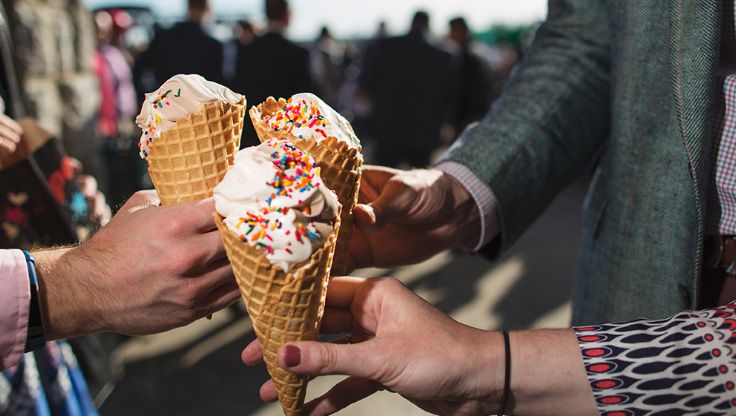 Multiple people holding ice cream cones