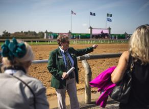 People touring keeneland. An expert showing the race track. 
