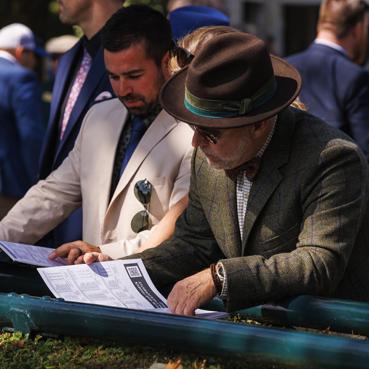 two men viewing a racing program