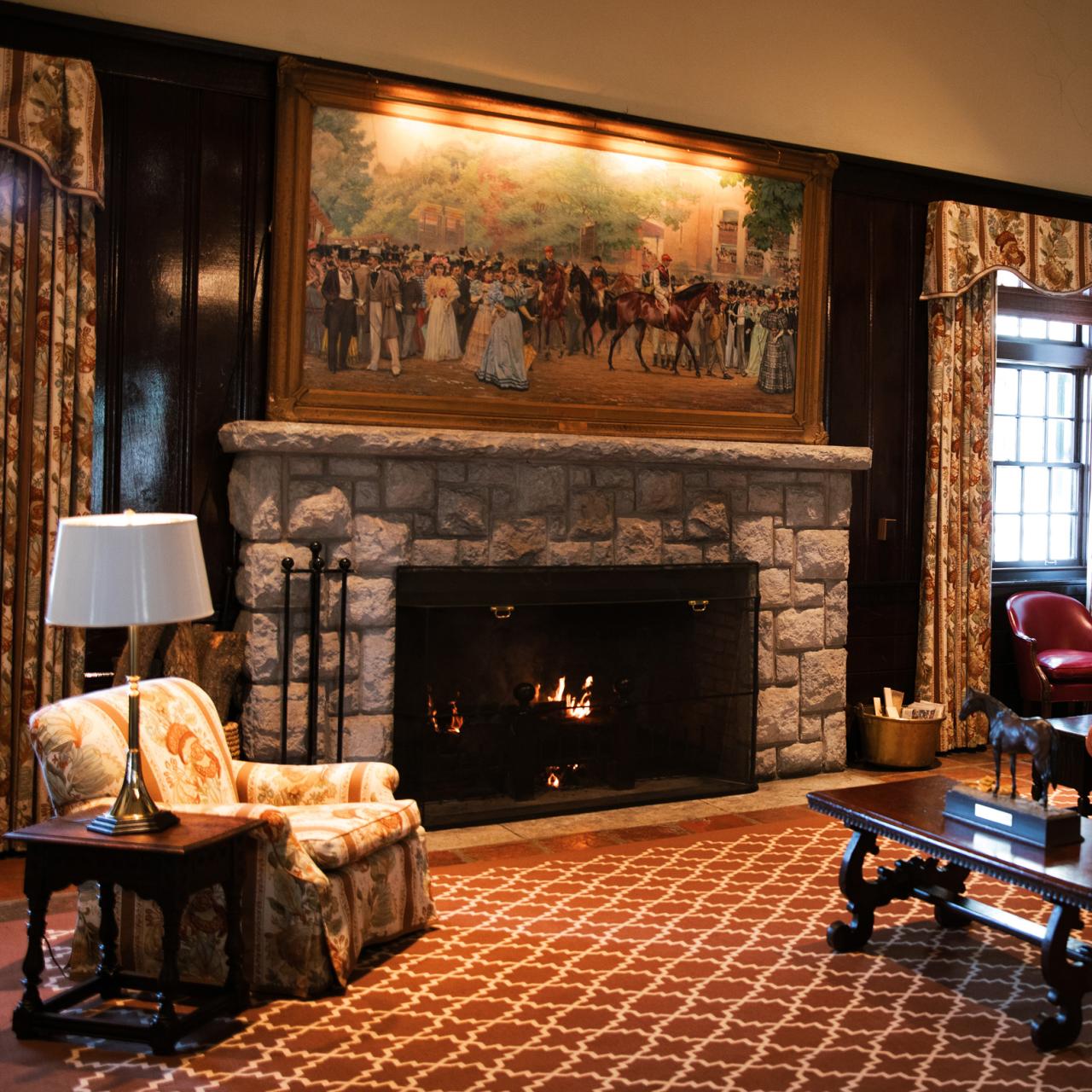 Keeneland clubhouse at a cozy day. Looking at the painting and fireplace on. 