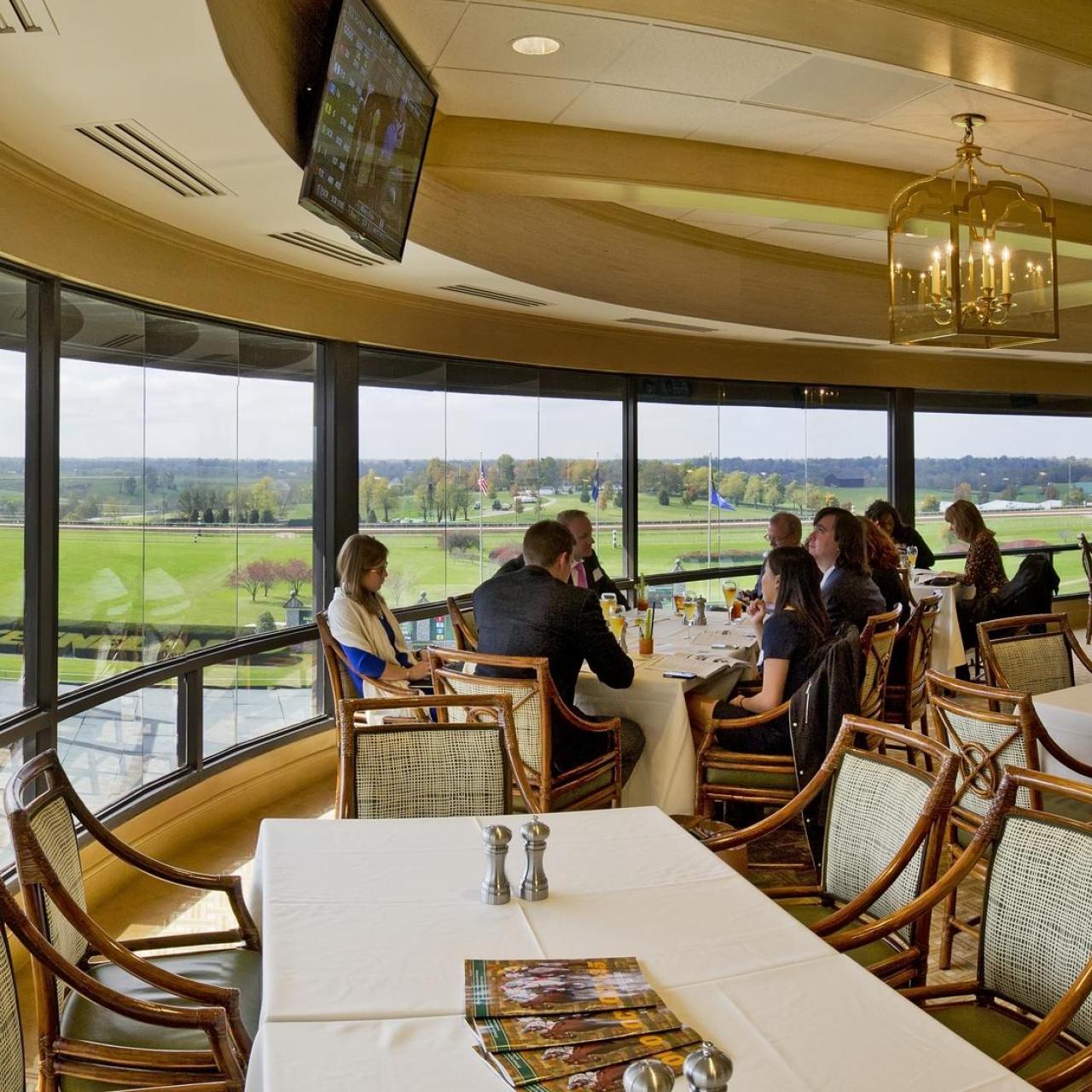 People having some dinner at the beautiful Keeneland Room. Located at the 5th floor and with a horse scenic. 